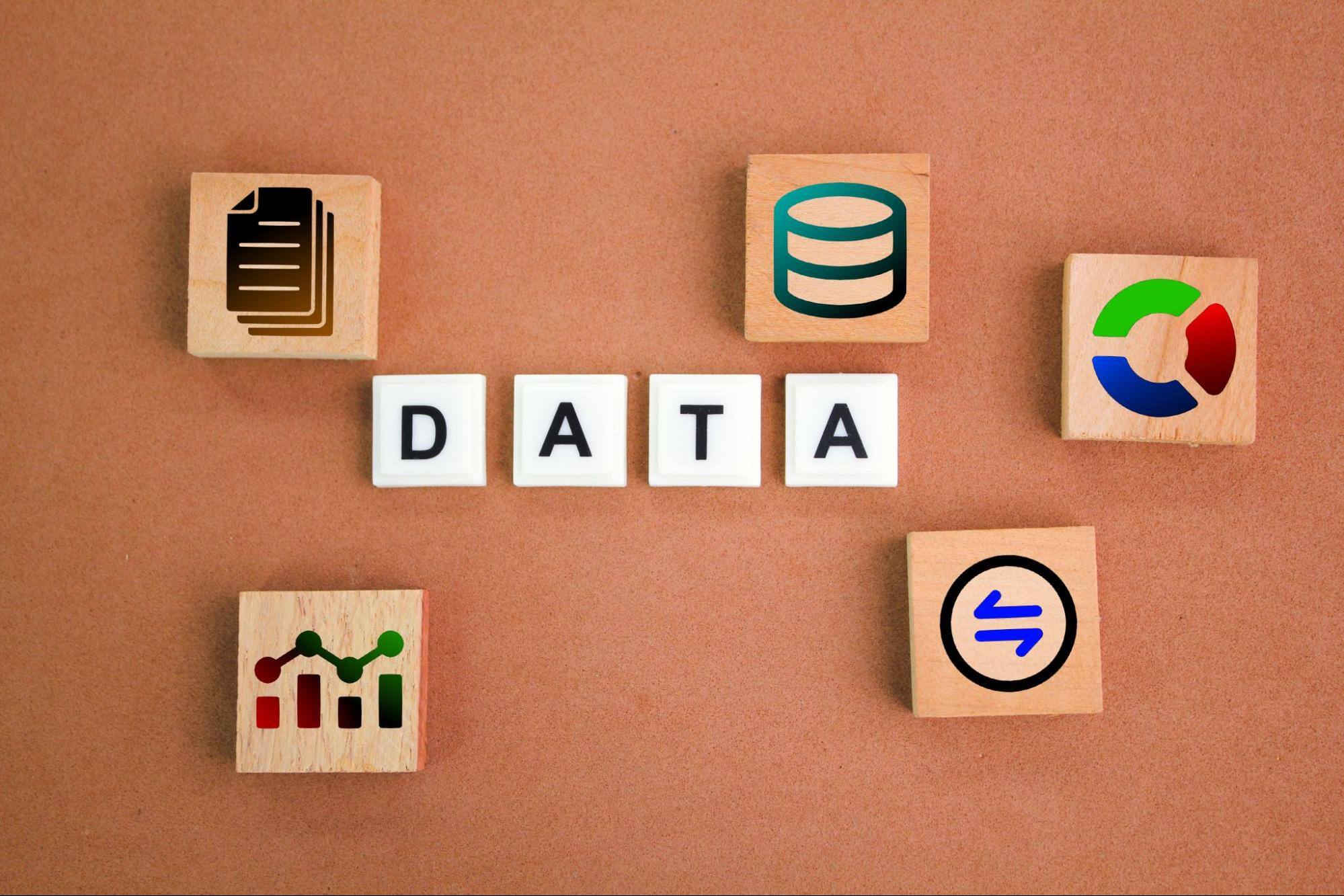  Wooden blocks that spell out “data” next to others with various logos and symbols. 