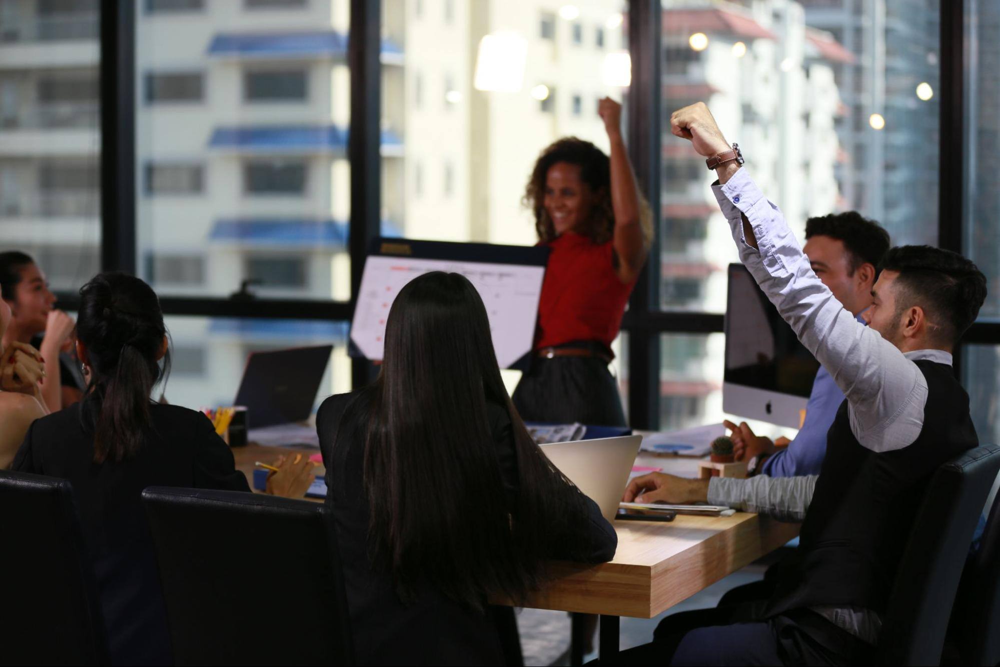 An office department discussing a presentation of their co-worker.