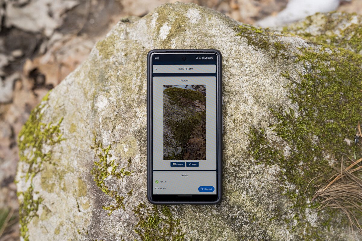 Cell phone on a rock with a screen capture from Eskuad. 